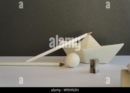 Desk of white pencil on a toy ship, Concept of creative work space and back to school Stock Photo