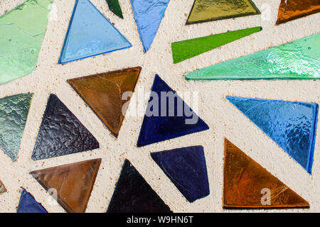 Mosaic surface made of multi-colored glass. Abstract mosaic glass tiles patterned background. CLose up. Stock Photo