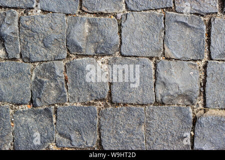 Texture of cobblestone in old town. Ancient gray pavement Stock Photo