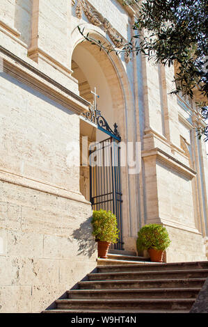 Entrance and stairway to Basilica di Santa Francesca Romana among green trees. Old town of Rome, Italy. Sunny autumn day Stock Photo