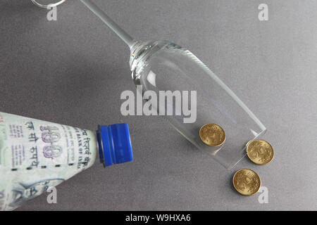 Five rupee coins Spilled out from champagne flute Stock Photo