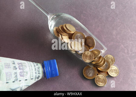 Indian coins Spilled out from champagne flute Stock Photo