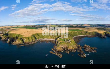 Aerial view of Dunnottar Castle a ruined medieval fortress located upon a rocky headland south of the town of Stonehaven, Aberdeenshire,  Scotland. Stock Photo