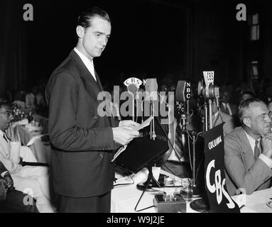 Vintage photo of American business tycoon, pilot, engineer, film producer and philanthropist Howard Hughes (1905 – 1976). The picture was taken as Hughes spoke at a National Press Club luncheon in Washington DC on July 21 1938, a few days after he set an aviation record by completing a round the world flight in just over 91 hours. Stock Photo