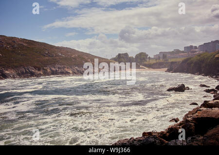 Picturesque view of an inlet beach on a hazy summer’s day in A Coruña, Spain. Stock Photo