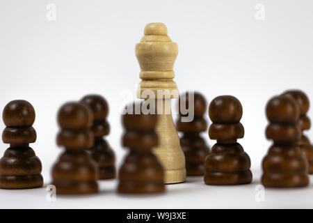 black chess figures surrounding the white king, 9 figures Stock Photo