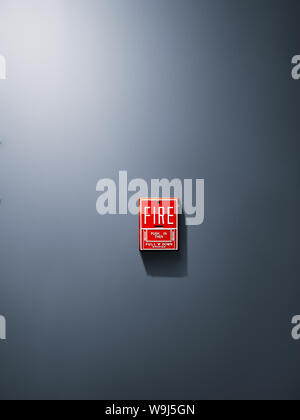 Switch to Fire alarm system on gray wall background. Stock Photo
