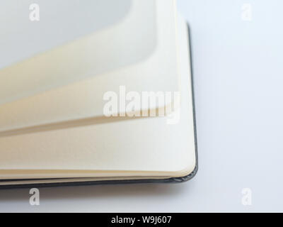Open the notebook or book with empty pages on isolate white background Stock Photo