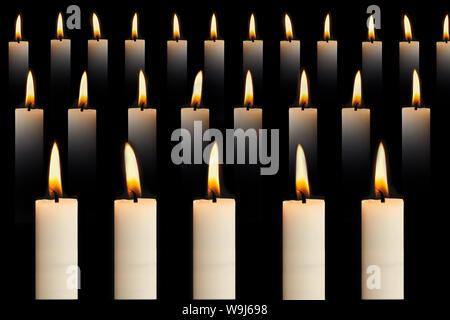 Many lit candles in rows on black background. Faith, religion, honor or spirituality concept. - Image Stock Photo