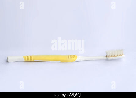 Used toothbrush on white background Stock Photo