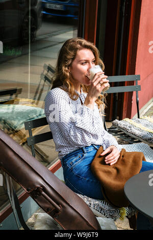 Young violinst on cafe terrace drinking coffee Stock Photo