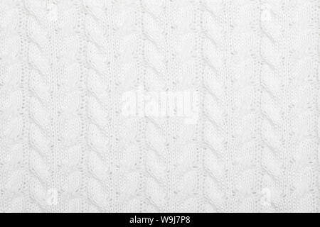 Real white knitted fabric with  cable pattern textured background Stock Photo
