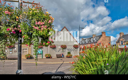 ALNESS ROSS AND CROMARTY SCOTLAND VILLAGE TOWN IN BLOOM PLETHORA OF COLOURFUL FLOWERS IN HANGING BASKETS AND CONTAINERS Stock Photo