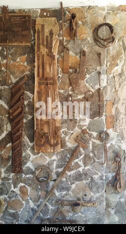 tools for working in the fields hanging on a wall Stock Photo