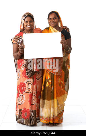 Two rural women showing a placard and smiling Stock Photo