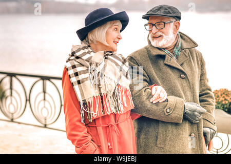 Smiling cute senior couple looking lovingly at each other Stock Photo