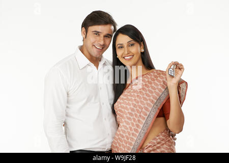 Young couple showing a house key Stock Photo