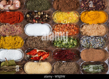 Multiple different spices in small containers Stock Photo