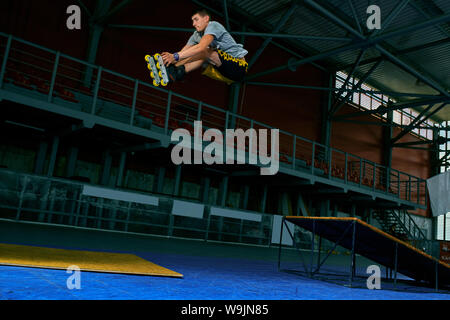 The man performs a trick. Jump. Indoor training Stock Photo