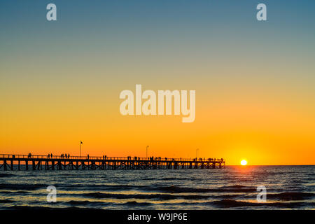 Semaphore Beach  jetty with people at sunset, South Australia Stock Photo