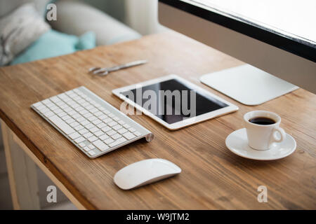 Picture of computer, scissors and camera on working desk Stock Photo
