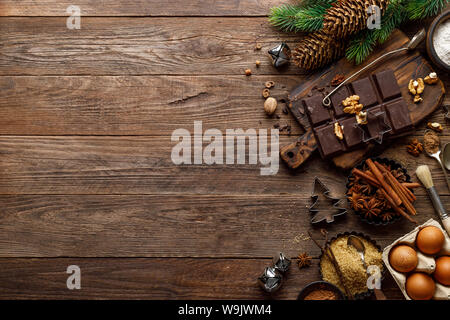 Christmas or new year culinary rustic wooden background with food ingredients for cooking festive dishes, xmas baking. Holiday cooking frame for Noel Stock Photo