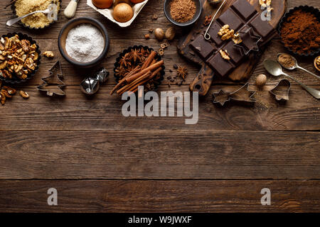 Christmas or new year culinary rustic wooden background with food ingredients for cooking festive dishes, xmas baking. Holiday cooking frame for Noel Stock Photo