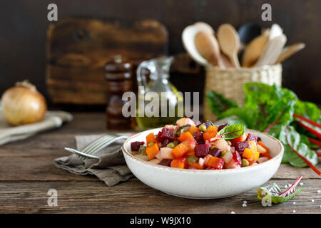 Beetroot or beet salad with boiled vegetables on wooden rustic table closeup Stock Photo