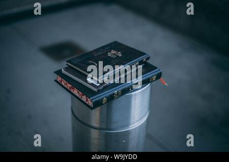 Closeup shot of three small black books stacked on one another Stock Photo