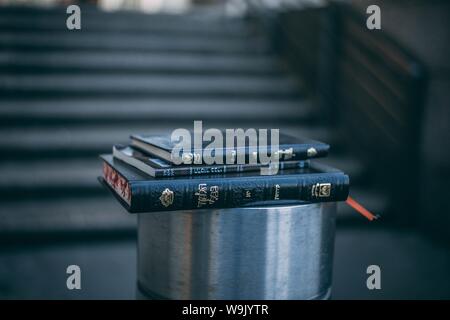 Closeup shot of three small black books stacked on one another Stock Photo