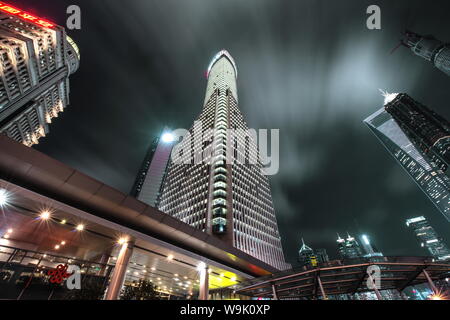 Low angle view of skyscrapers in Shanghai Pudong at night, with moving clouds, Shanghai, China, Asia Stock Photo