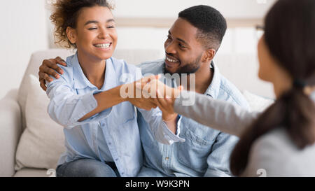 Gladful Afro Spouses Shaking Hands With Marriage Counselor In Office Stock Photo