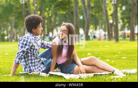 Romantic date in park. Teenage couple enjoying time together. Stock Photo