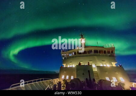 Aurora borealis (Northern Lights) dance above the Lindblad Expeditions ship National Geographic Explorer in Hudson Strait, Nunavut, Canada Stock Photo