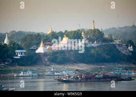 View of buddhist temples on Sagaing hill and the Irrawaddy or Ayeyarwady river from the Mandalay side of the river, Sagaing, Myanmar, Southeast Asia Stock Photo