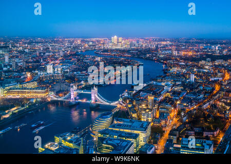 High view of London skyline at dusk along the River Thames from Tower Bridge to Canary Wharf, London, England, United Kingdom, Europe Stock Photo