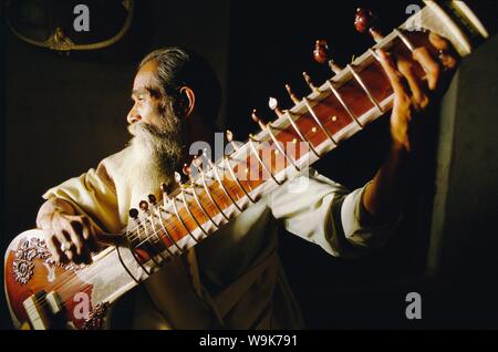 Portrait of an elderly man playing the sitar, India Stock Photo