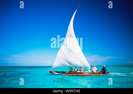 Outrigger canoe with sail on Indian Ocean, off Jambiani, Zanzibar, Tanzania, East Africa, Africa Stock Photo