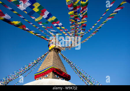 Bodhnath Stupa, one of the holiest Buddhist sites in Kathmandu, UNESCO, with colourful prayer flags against clear blue sky, Kathmandu, Nepal Stock Photo