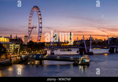 Millenium Wheel (London Eye) with Big Ben on the skyline beyond at sunset, London, England, United Kingdom, Europe Stock Photo