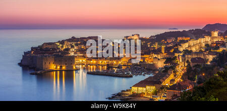 Aerial panorama of Dubrovnik Old Town at night with orange sunset sky, UNESCO World Heritage Site, Dubrovnik, Dalmatian Coast, Croatia, Europe Stock Photo