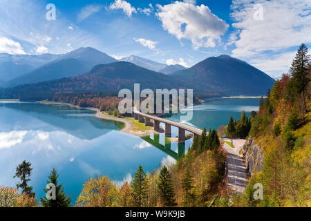 Reflections of a road bridge over Lake Sylvenstein, with mountains in the background, Bavaria, Germany, Europe Stock Photo