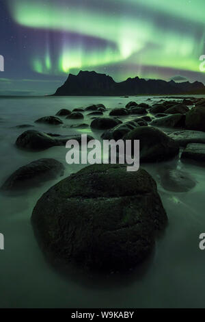 Aurora borealis (Northern Lights) over a mountain at Uttakleiv, Lofoten Islands, Arctic, Norway, Scandinavia, Europe Stock Photo