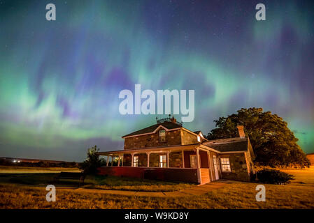 Heart-shaped Aurora Borealis over the historic Goodwin House at the Saskatchewan Landing in Saskatchewan, Canada Stock Photo