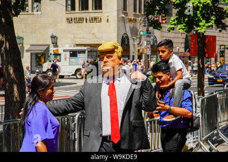 Trump puppet greeting South American pedestrians in front of Trump Hotel, 5th ave, Manhattan, New York City August 2019, USA. Stock Photo