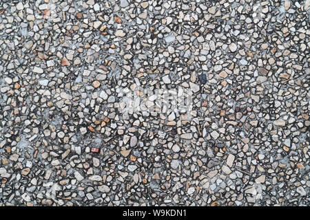 Grunge pebble floor as seamless textured background.Small pebbles mixed with sand texted background. Stock Photo