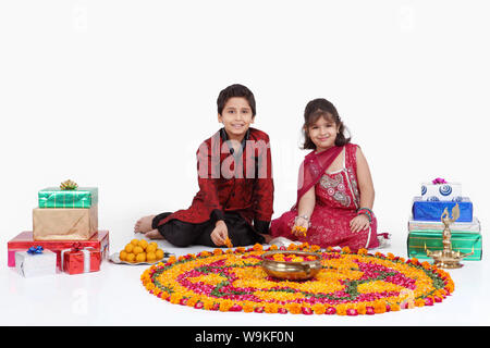 Two children making rangoli Stock Photo