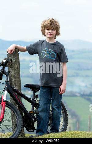 Young boy bicycling on a sunny day Stock Photo