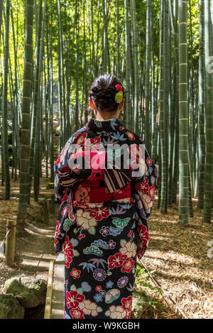 Women wearing Japanese kimono walking in bamboo forest in Japan Stock Photo