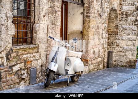 Gubbio, Italy - 11 August, 2019: Old Italian scooter parked in a street of the city of Gubbio, Umbria Stock Photo